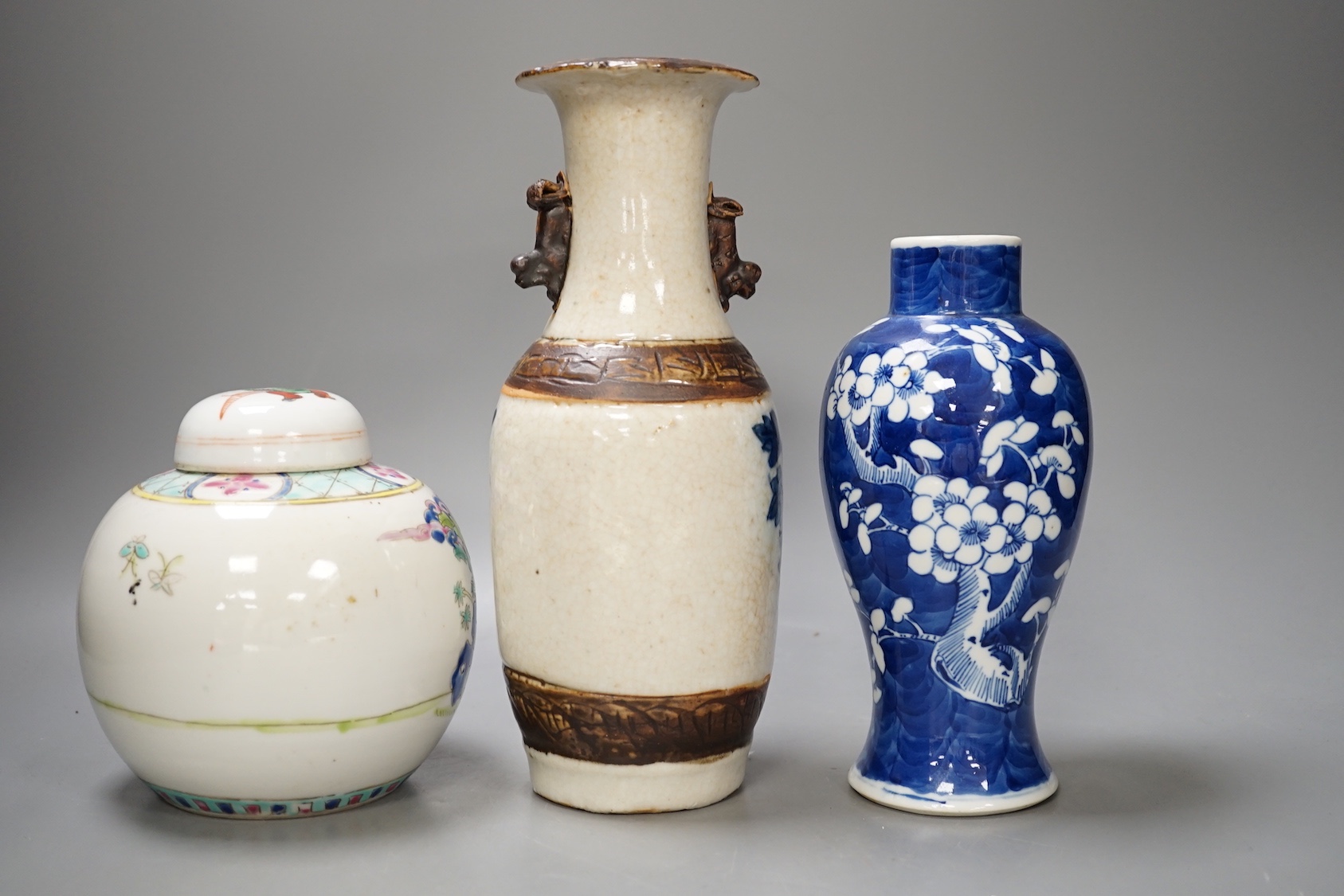 A 19th century Chinese blue and white prunus jar, a crackle glaze vase and a famille rose jar and cover